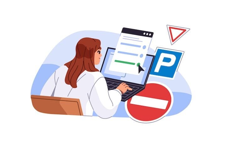 Person taking an online driver’s ed course on a laptop while reviewing road signs