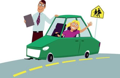 Instructor stands beside a teen driver during a driving lesson