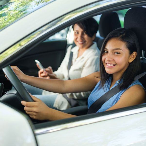 mom teaching daughter to drive