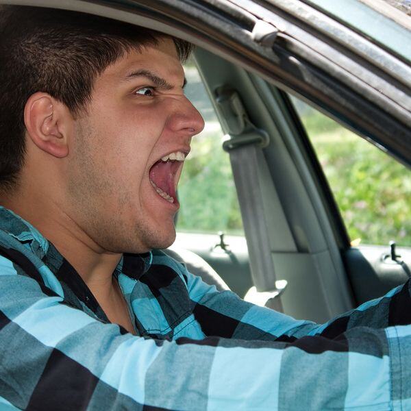 Image of an angry man screaming in his car Image of an angry man screaming in his car
