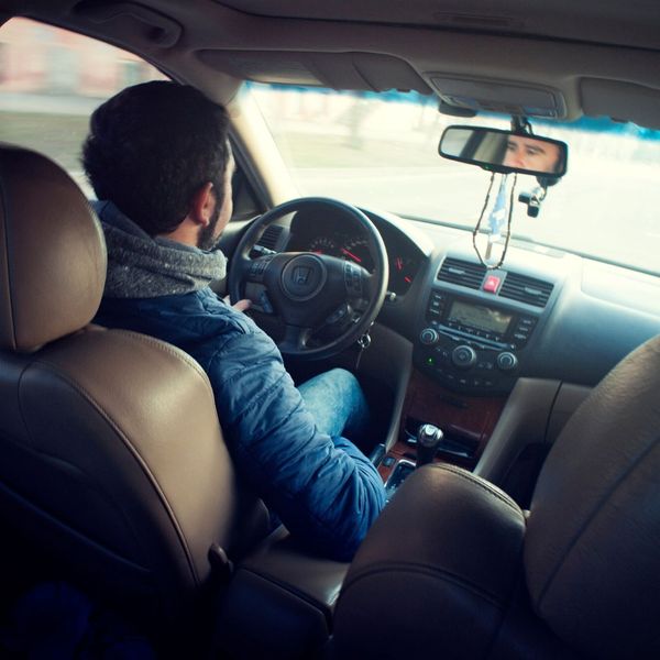 man driving car
