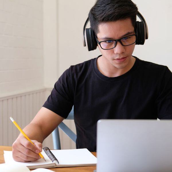 Teen boy studying at a laptop